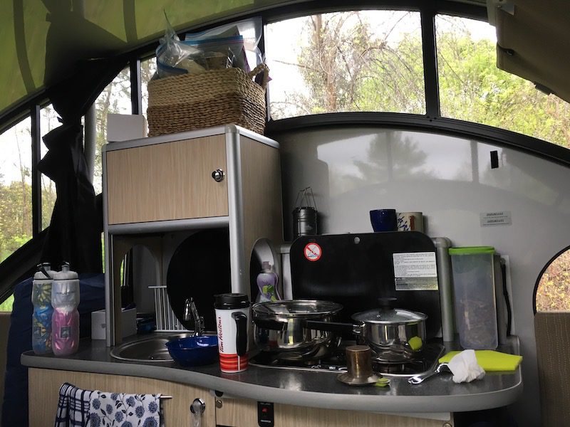 Springtime glamping showing interior of Alto 1713 trailer with stove and makings for tea and hot chocolate