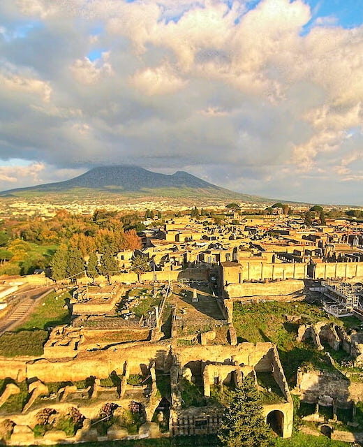 Ruins of Pompeii seen from the above with a drone, with the Vesuvius in the background.