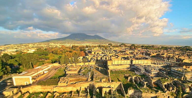 Ruins of Pompeii seen from the above with a drone, with the Vesuvius in the background.