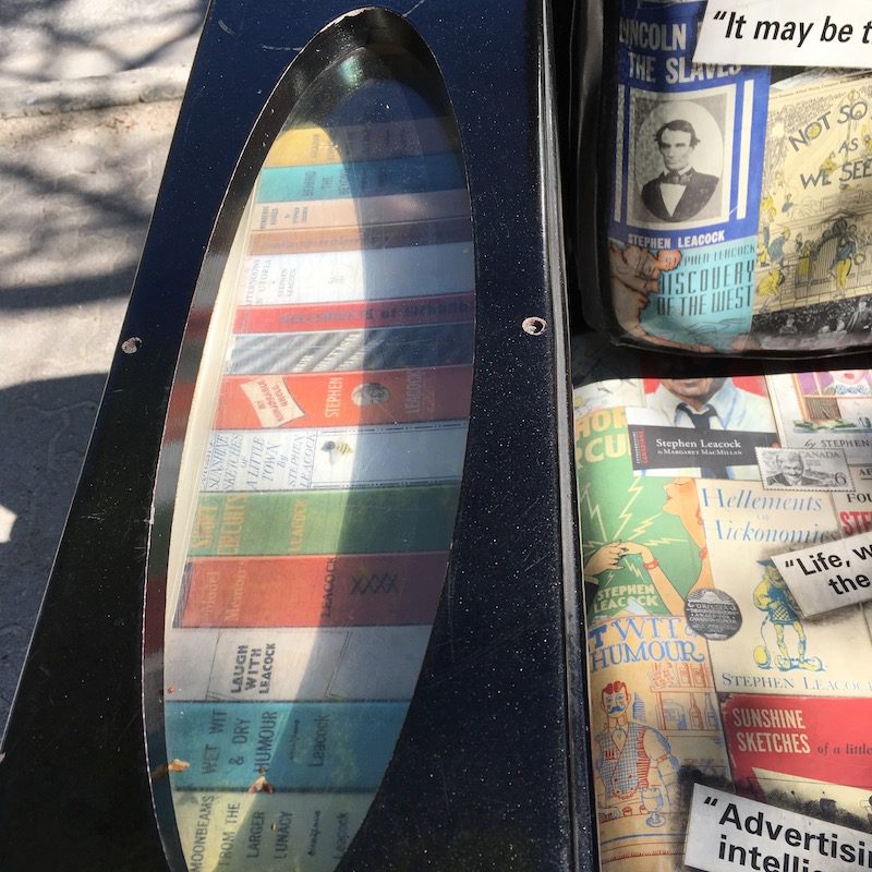 detail of arm inset showing Canadian literature book spines, of Stephen Leacock chair, Streets Alive! festival, Orillia