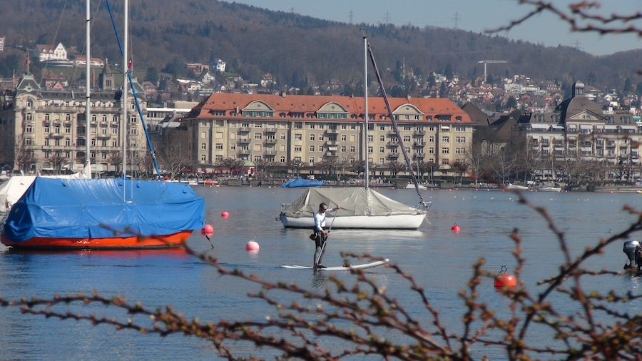 Paddleboarder on he water in early Spring in Zurich.