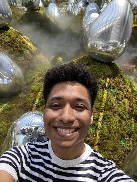 Smiling young man in the Moss Garden at teamLab Planets.