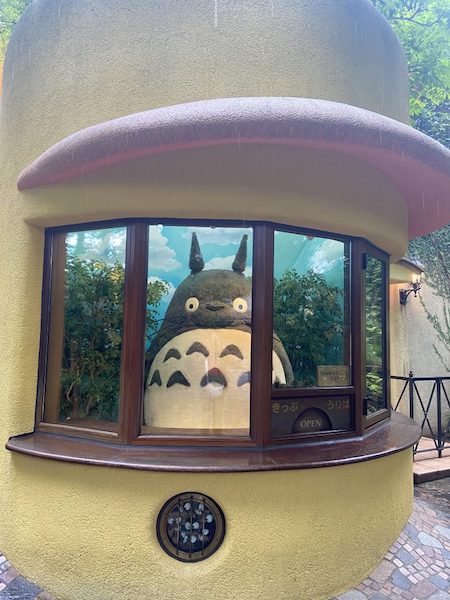 Totoro gazing back from the ticket box window.
