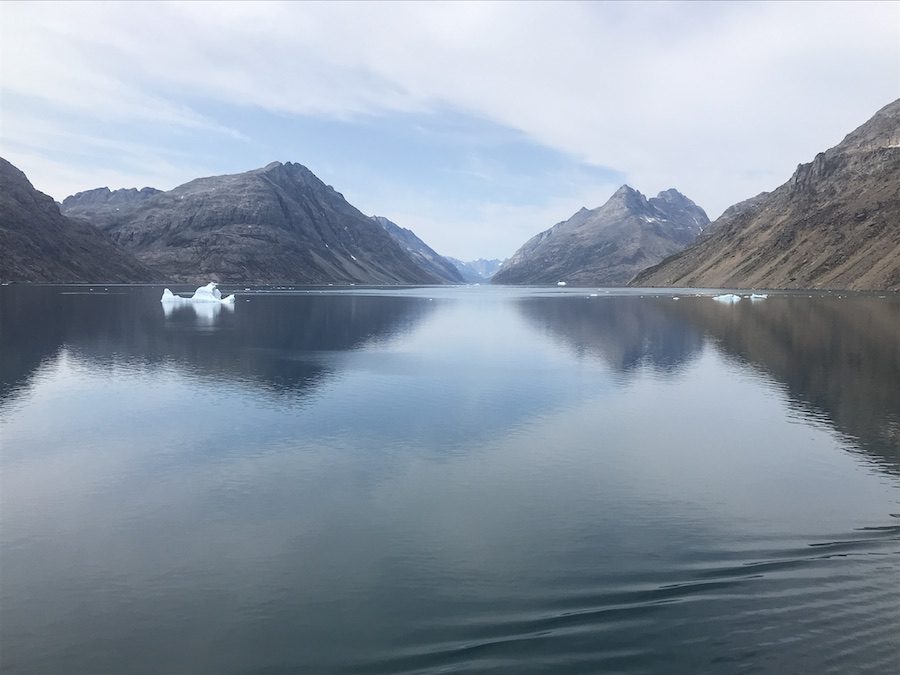 Beautiful fjords and glassy calm waters while cruising from Iceland to Greenland.