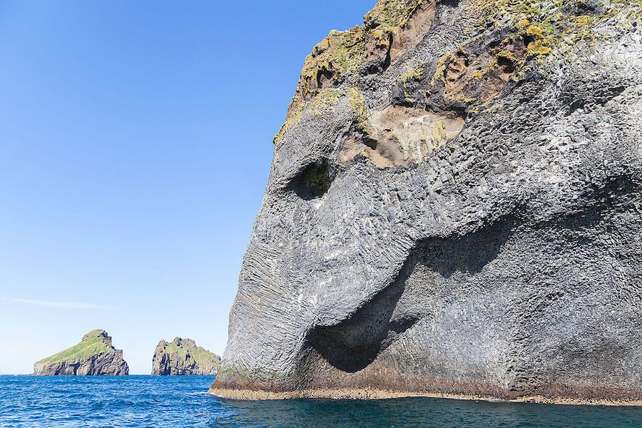 Elephant Rock on Heimaey Island, a rock in Herjolfsdalur Valley shaped like an elephant's head with its trunk submerged in the ocean.
