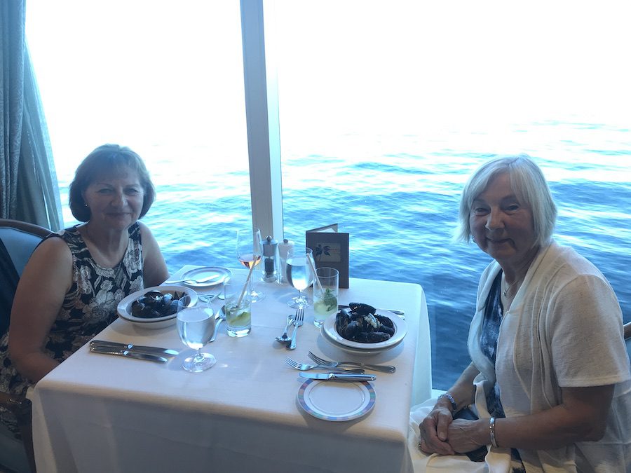 Anne and Vera enjoying mussels and a view on the Oceania Insignia.