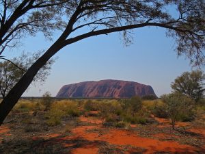 Uluru stands like a freshly baked loaf on the dry, dusty landscape.