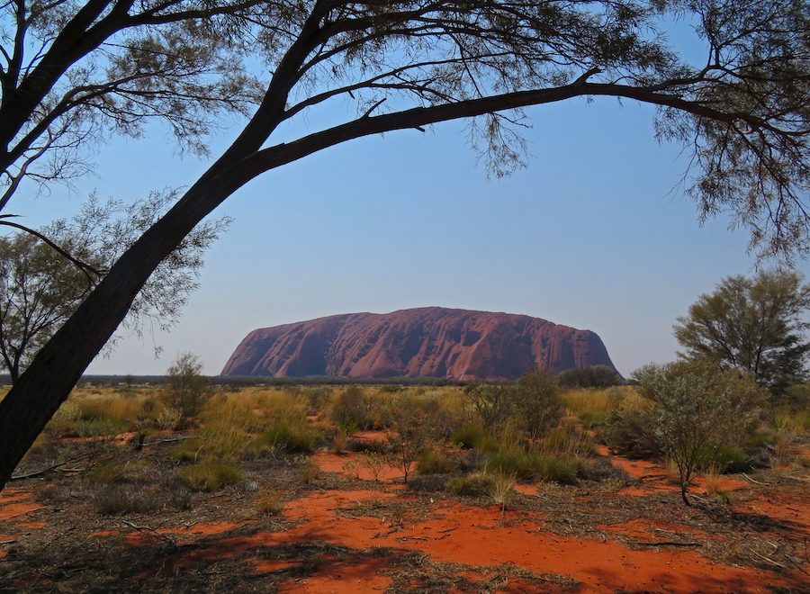 Uluru stands like a freshly baked loaf on the dry, dusty landscape.