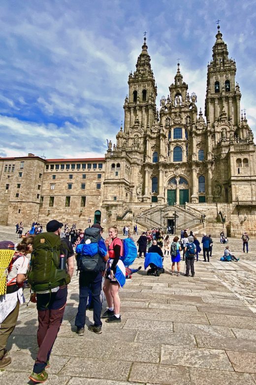 Pilgrims arriving at Praza do Obradoiro, dominated by the Cathedral of Santiago de Compostela.