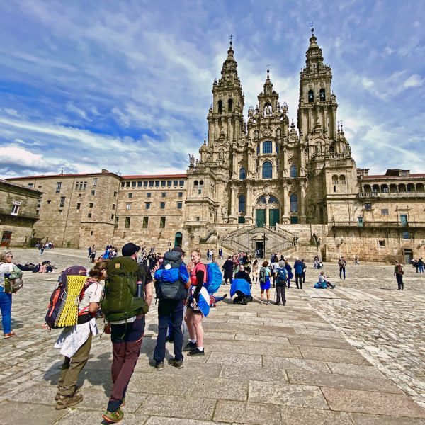 Pilgrims arriving at Praza do Obradoiro, dominated by the Cathedral of Santiago de Compostela.