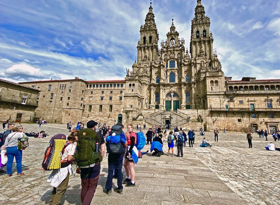 Pilgrims arriving at Praza do Obradoiro, dominated by the Cathedral of Santiago de Compostela.