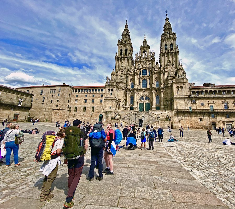 Pilgrims arriving at Praza do Obradoiro, dominated by the Cathedral of Santiago de Compostela.