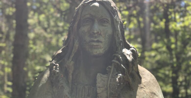 Gerry Squire's Spirit of Shanawdithit statue in the forest on the trail to the Beothuk Village at the Beothuk Interpretation Centre in Boyd's Cove, Newfoundland.