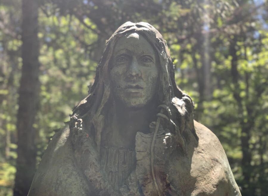 Gerry Squire's Spirit of Shanawdithit statue in the forest on the trail to the Beothuk Village at the Beothuk Interpretation Centre in Boyd's Cove, Newfoundland.