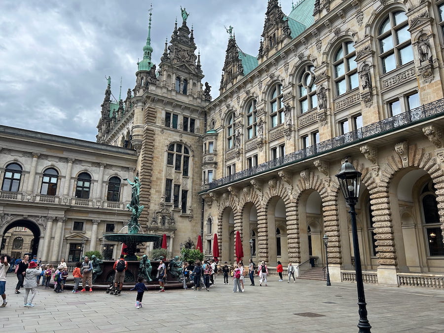 People gathered around the communal fountain at Hamburg Town Hall.