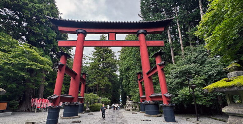 A clearly marked central path through the red torii gates is for the sacred at Sengen Jinja shrine.