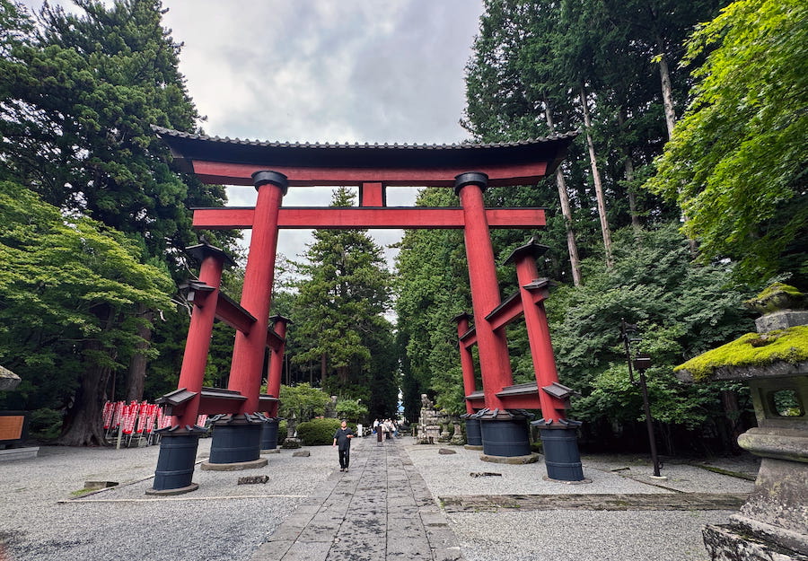 A clearly marked central path through the red torii gates is for the sacred at Sengen Jinja shrine. Staying to one side is part of Japanese culture at shrines and temples in Japan.