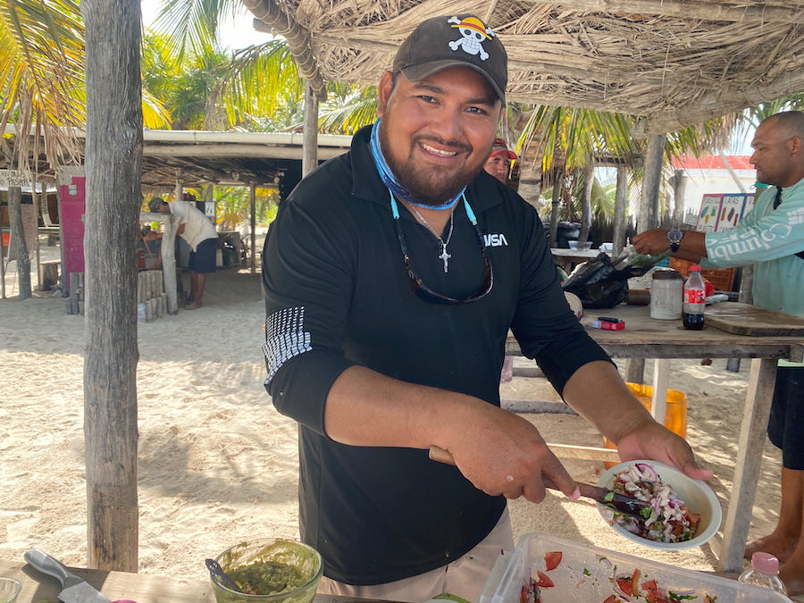 Captain José Elias Celina making ceviche from freshly caught fish, underneath the open air palm frond huts on Cabo Catoche.