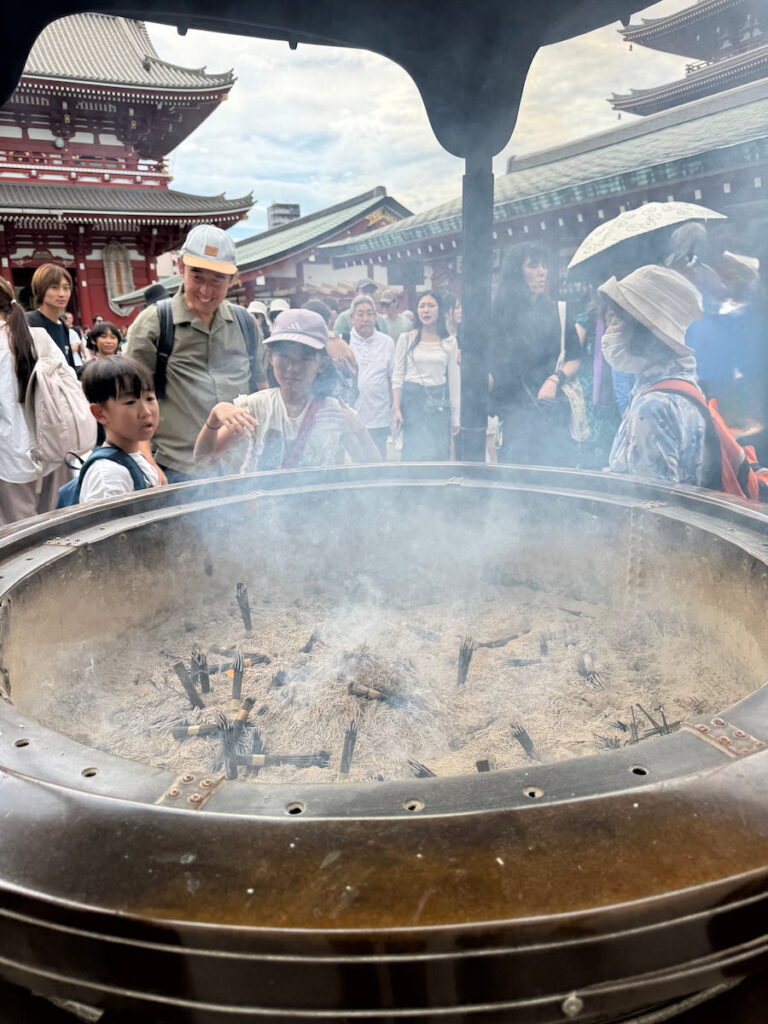 Incense bundles are lit at the giant incense burner at Sensoji Temple. Part of Japanese culture at shrines and temples in Japan.