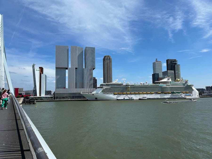 The cruise ship Independence of the Sea docked in Rotterdam with  the city's unique modern architecture creating an interesting skyline.