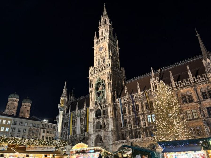 The neolithic architecture of Rathaus-Glockenspiel towering over the Munich Marienplatz Christmas Market.