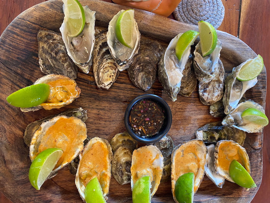 Oysters on the half shell with wedges of lime at Bocamar l Marisqueria l del mar al Paladar.