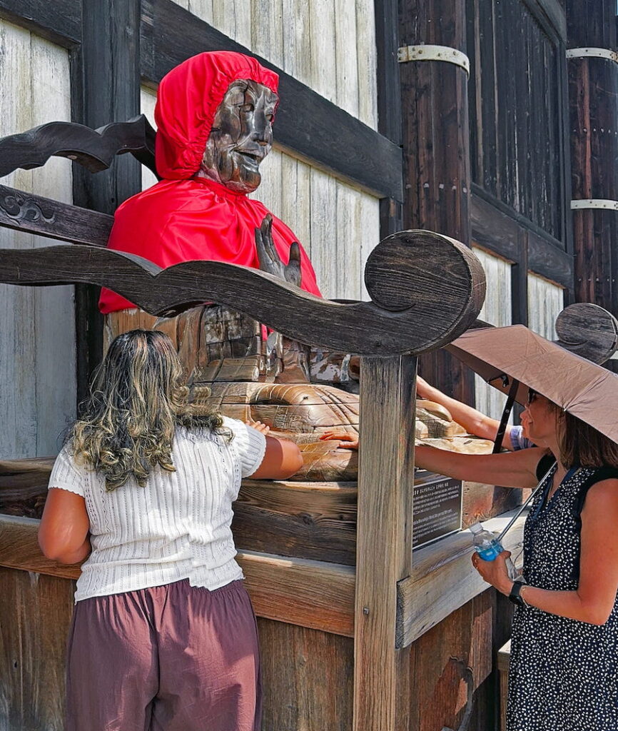 People rub Binzuru, a Buddhist deity. He sits outside temples and is said to heal the rubbed areas on those rubbing Binzuru. Part of Japanese culture at shrines and temples in Japan.