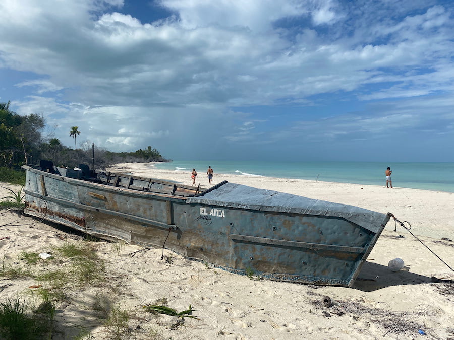 An abandoned skiff on the white sandy shores of Cabo Catoche.