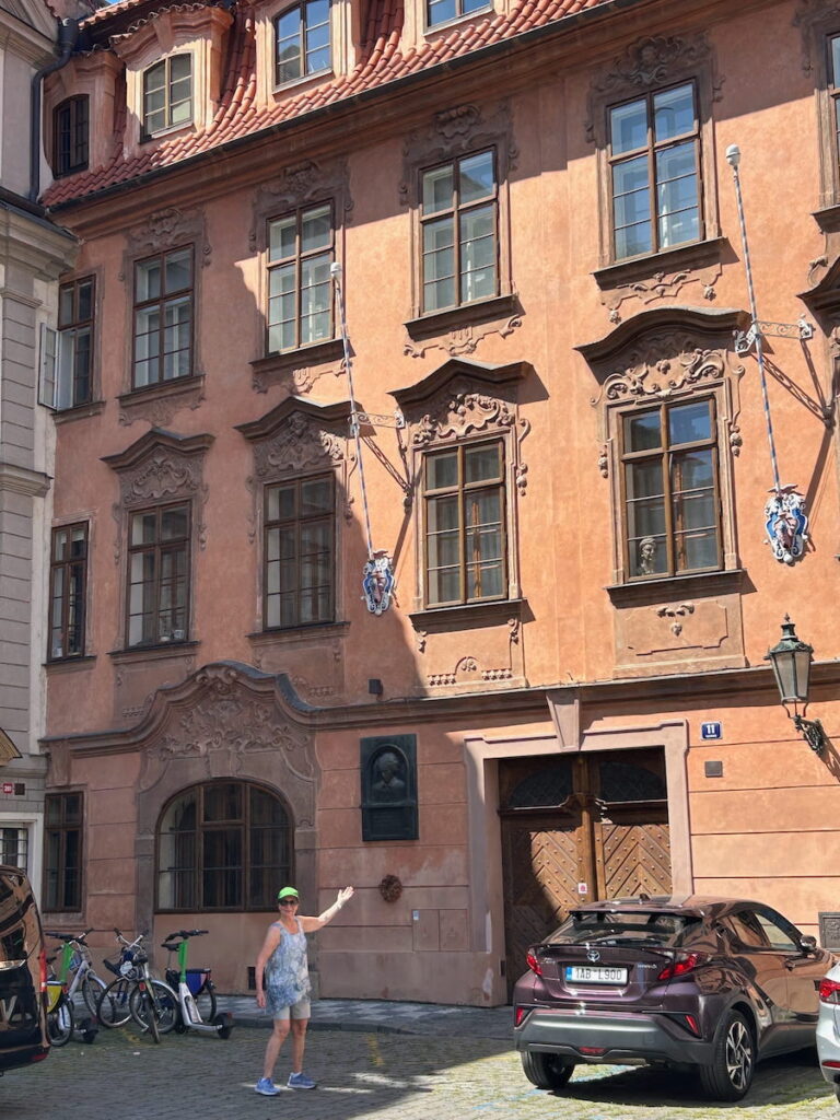 Anne pointing to 11 Lazenska St, the home where Beethoven once lived in Prague, Czechia.