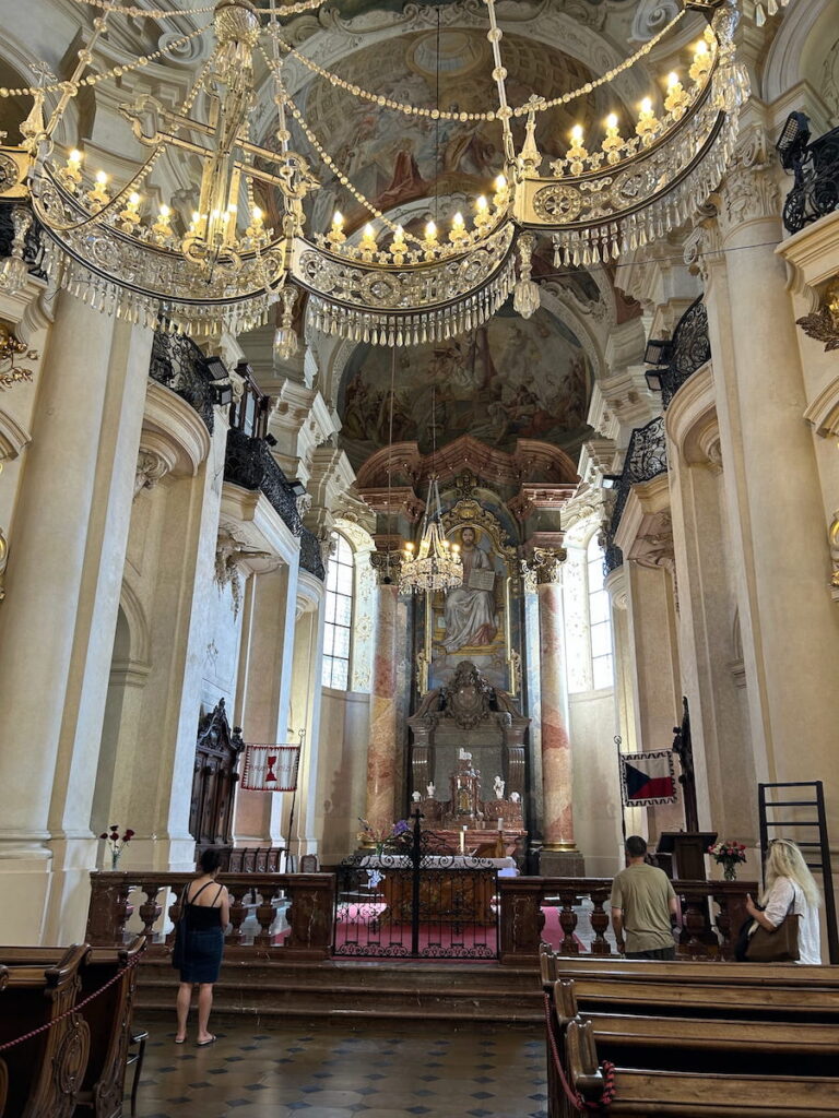 The ornately vaulted ceiling inside St. Nicholas Church in Prague, Czechia.