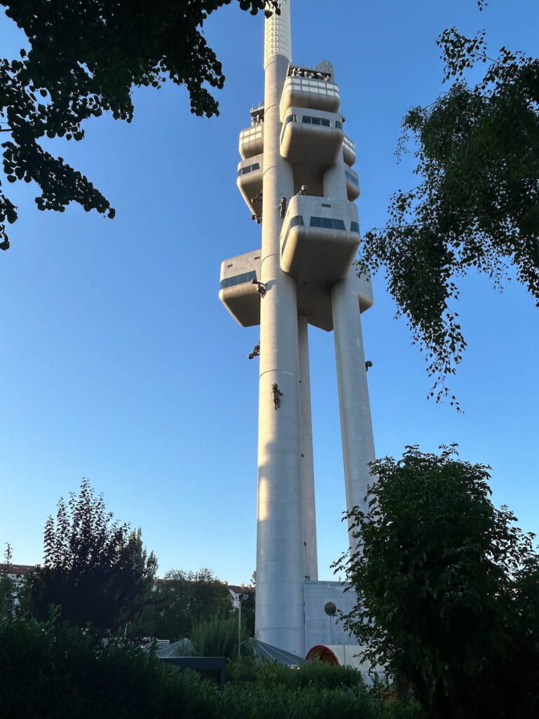 Statues of crawling miminka (babies), sculpted by David Cerny, climbing a TV Tower in Zizkov, a neighbourhood of Prague, Czechia.
