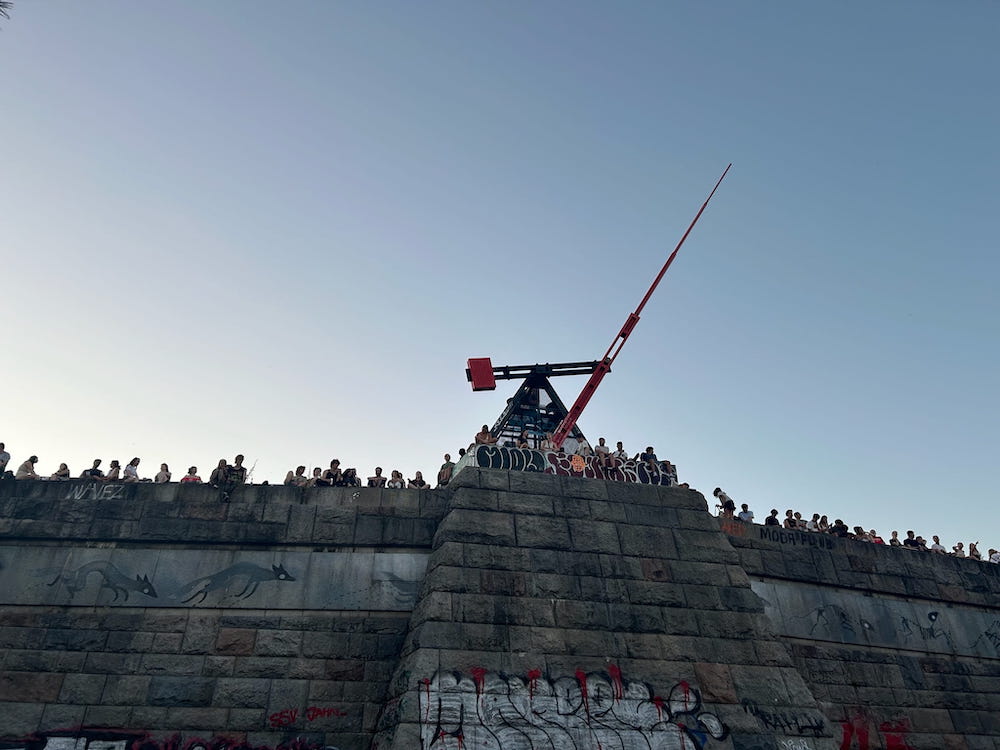 People enjoying the view of sunset over Prague, Czechia from the Prague Metronome.
