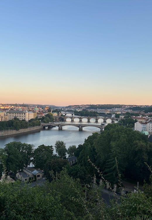 Views over the Vtlava River from Letna Park at sunset.