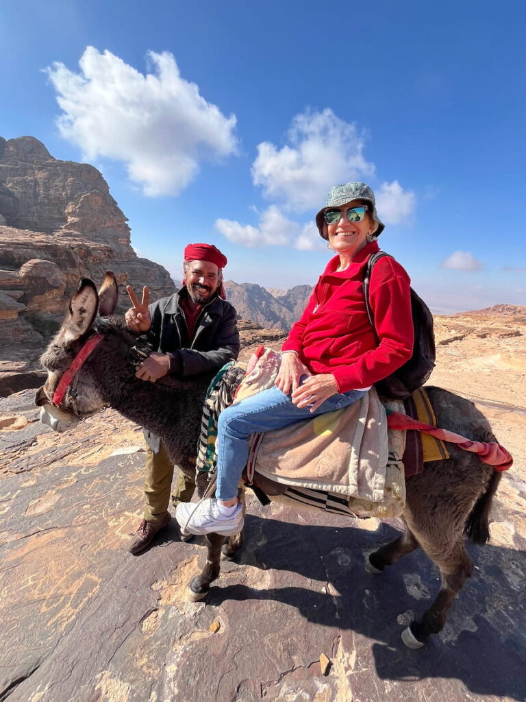 Ahmed gives the thumbs up while Liz gets used to her precarious perch atop his donkey's back.