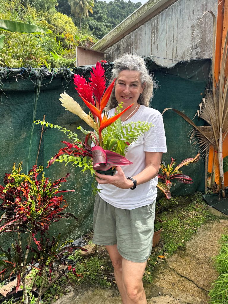 Writer Diana Ballon proudly holds up the floral arrangement that she created at Jardin de la Montagne.