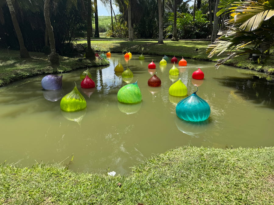 Glass art bulbs decorate the pond in the garden at Habitation Clement.