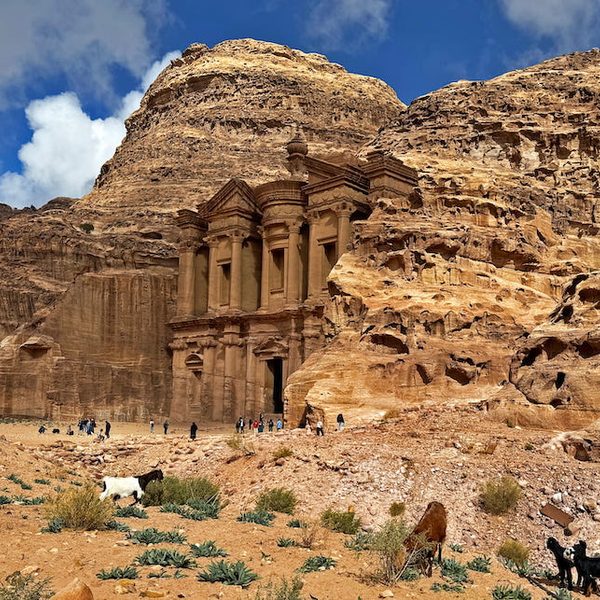 Goats, donkeys, and visitors wander around in front of Ad-Dayr.