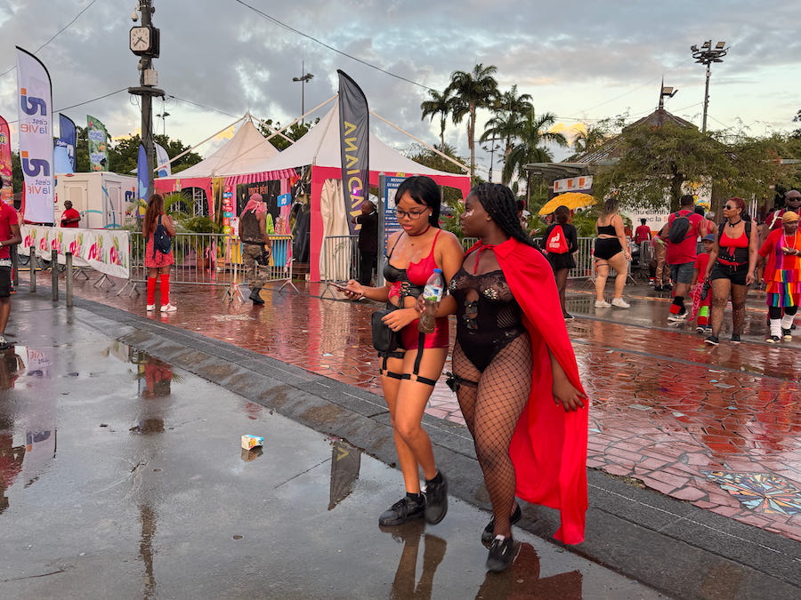 People walk the streets dressed in red on Red Devils Day at the Martinique Carnival.