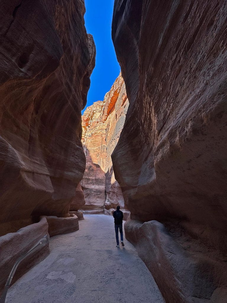 Walking through Al Siq, the walls of the gorge rise steeply on either side but the colours change as you move along its length.