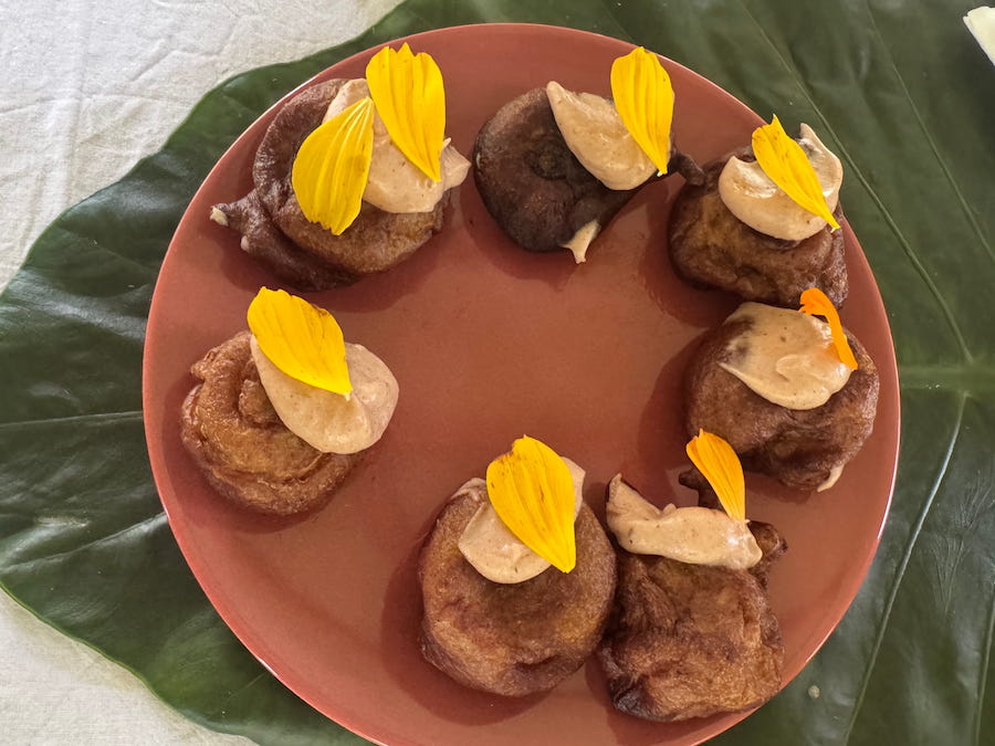 Beignets de banane laid out on a brown plate - a Chef Sterelle creation.